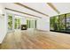 Spacious living room with wood floors, fireplace, beam ceilings, large windows and natural light at 1026 Reeder Cir, Atlanta, GA 30306