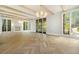 Stunning living room featuring herringbone floors, fireplace, beamed ceiling, and abundant natural light at 1026 Reeder Cir, Atlanta, GA 30306