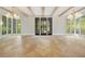 Elegant living room with herringbone wood floors, bright windows and modern chandeliers at 1026 Reeder Cir, Atlanta, GA 30306