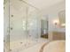 Luxurious bathroom with marble floors, walk-in glass shower, soaking tub, double vanity, and walk-in closet at 1026 Reeder Cir, Atlanta, GA 30306
