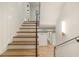 Bright staircase leads to multiple rooms and features new paint and modern lighting at 1026 Reeder Cir, Atlanta, GA 30306
