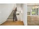 Staircase with wood steps and iron railing, leading to an open living area with herringbone hardwood floors at 1026 Reeder Cir, Atlanta, GA 30306