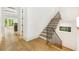 Modern staircase with wooden treads, iron railings, and white walls, with a view to another room at 1026 Reeder Cir, Atlanta, GA 30306