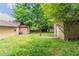 Backyard showing grass, storage shed, the side of the house, and an air conditioning unit at 1615 Enchanted Forest Dr, Conley, GA 30288