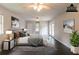 This staged large bedroom features hardwood floors, and double closets at 1615 Enchanted Forest Dr, Conley, GA 30288