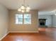 Cozy dining area with chandelier lighting and access to the living room at 1615 Enchanted Forest Dr, Conley, GA 30288