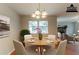 This staged dining room features chandelier lighting with an open floor plan at 1615 Enchanted Forest Dr, Conley, GA 30288