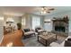 This staged living room features hardwood floors and a stone fireplace at 1615 Enchanted Forest Dr, Conley, GA 30288