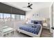 Relaxing bedroom with city views, nautical themed bedding, and bright natural light from the windows at 215 Piedmont Ne Ave # 2210, Atlanta, GA 30308