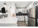 Bright kitchen with stainless steel refrigerator, white cabinets, black tile backsplash, and bar seating at 215 Piedmont Ne Ave # 2210, Atlanta, GA 30308