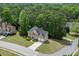 Wide aerial shot of a beautiful brick home, surrounded by green lawn and mature trees at 4290 Grand Teton Pkwy, Suwanee, GA 30024
