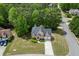 Aerial view of a well-maintained home with lush greenery and a long driveway at 4290 Grand Teton Pkwy, Suwanee, GA 30024