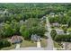 High aerial view showcasing a neighborhood with lush trees and well-maintained homes at 4290 Grand Teton Pkwy, Suwanee, GA 30024