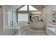 Bright bathroom featuring a shower and tub with triangular windows above the tub allowing for natural light at 4290 Grand Teton Pkwy, Suwanee, GA 30024