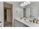 Bathroom featuring dual sinks and a door leading to another room at 4290 Grand Teton Pkwy, Suwanee, GA 30024