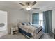 Bedroom featuring a ceiling fan, television, window with curtains and a bed at 4290 Grand Teton Pkwy, Suwanee, GA 30024