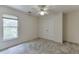 Cozy bedroom features neutral carpet, ceiling fan, and double door closet at 4290 Grand Teton Pkwy, Suwanee, GA 30024