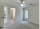 Neutral carpeted bedroom with ceiling fan and access to an ensuite bathroom at 4290 Grand Teton Pkwy, Suwanee, GA 30024