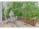 Wooden deck space with seating, table and wooded surround at 4290 Grand Teton Pkwy, Suwanee, GA 30024