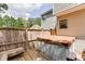 Private deck area with hot tub, bench seating, and wooded views at 4290 Grand Teton Pkwy, Suwanee, GA 30024