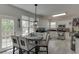 Bright eat-in kitchen with white cabinetry, stainless steel appliances, and a breakfast table next to the window at 4290 Grand Teton Pkwy, Suwanee, GA 30024