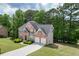 Beautiful brick home with a two-car garage, a large lawn, and mature landscaping at 4290 Grand Teton Pkwy, Suwanee, GA 30024