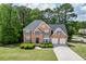 Charming two-story brick home with a well-manicured lawn and a two-car garage at 4290 Grand Teton Pkwy, Suwanee, GA 30024