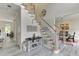 Inviting foyer features a staircase with wooden railings, complemented by stylish decor and light wood-look floors at 4290 Grand Teton Pkwy, Suwanee, GA 30024
