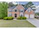 Charming brick home with a well-manicured lawn and beautiful landscaping, creating inviting curb appeal at 4290 Grand Teton Pkwy, Suwanee, GA 30024