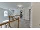 Hallway with a view to a bedroom and railing that overlooks the main floor of the home at 4290 Grand Teton Pkwy, Suwanee, GA 30024