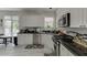 Bright kitchen with white cabinetry, granite countertops, and stainless steel appliances at 4290 Grand Teton Pkwy, Suwanee, GA 30024