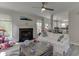 Cozy living room with a fireplace, white sofas, and open layout connecting to the kitchen at 4290 Grand Teton Pkwy, Suwanee, GA 30024