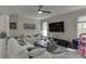 Bright living room featuring white sofas, a ceiling fan, and plenty of natural light at 4290 Grand Teton Pkwy, Suwanee, GA 30024