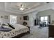 Large main bedroom features a tray ceiling, a ceiling fan, and plenty of natural light at 4290 Grand Teton Pkwy, Suwanee, GA 30024