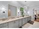 Spacious bathroom with double vanity, large mirrors, and modern lighting at 5134 Pratt Sw St, Covington, GA 30014