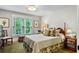 Comfortable bedroom with a queen-size bed, bedside tables, and a large window letting in natural light at 5134 Pratt Sw St, Covington, GA 30014