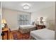 Bright bedroom with two twin beds, natural light from the window, and classic furnishings at 5134 Pratt Sw St, Covington, GA 30014