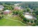 Aerial view of a community pool area, with a swimming pool, patio, and surrounding green space at 5134 Pratt Sw St, Covington, GA 30014