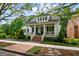 Charming two-story home with a welcoming front porch, landscaped yard, and brick pathway at 5134 Pratt Sw St, Covington, GA 30014