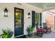 Cozy front porch with rocking chairs, elegant lanterns, and a stylish front door, perfect for outdoor seating at 5134 Pratt Sw St, Covington, GA 30014