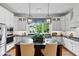 Kitchen with island, stainless appliances, and modern lighting fixtures at 5134 Pratt Sw St, Covington, GA 30014