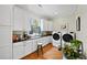 Well-appointed laundry room includes ample cabinetry, counter space, and modern washer and dryer at 5134 Pratt Sw St, Covington, GA 30014