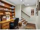 Charming home office featuring custom built-ins, a cozy desk area, and hardwood stairs nearby at 5134 Pratt Sw St, Covington, GA 30014
