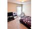 Neutral bedroom with window, TV, comfy chair and a bed with a unique cover at 635 Crosswinds Cir, Marietta, GA 30008