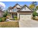 Charming two-story home with a stone and siding facade, a covered front porch, and a well-manicured lawn at 635 Crosswinds Cir, Marietta, GA 30008