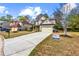 Suburban home featuring a long driveway, well-kept lawn, and traditional two-story architecture at 635 Crosswinds Cir, Marietta, GA 30008