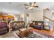 Open living room boasts hardwood floors, ceiling fan, staircase, and view into the kitchen at 635 Crosswinds Cir, Marietta, GA 30008