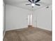 Bedroom featuring neutral carpet, white walls, ceiling fan, and doorway to another room at 1250 Parkwood Se Cir # 3101, Atlanta, GA 30339
