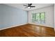 Bedroom featuring hardwood floors, a ceiling fan, and a large window with natural light at 1250 Parkwood Se Cir # 3101, Atlanta, GA 30339