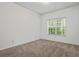 Cozy bedroom featuring neutral carpet, a bright window, and fresh white walls at 1250 Parkwood Se Cir # 3101, Atlanta, GA 30339